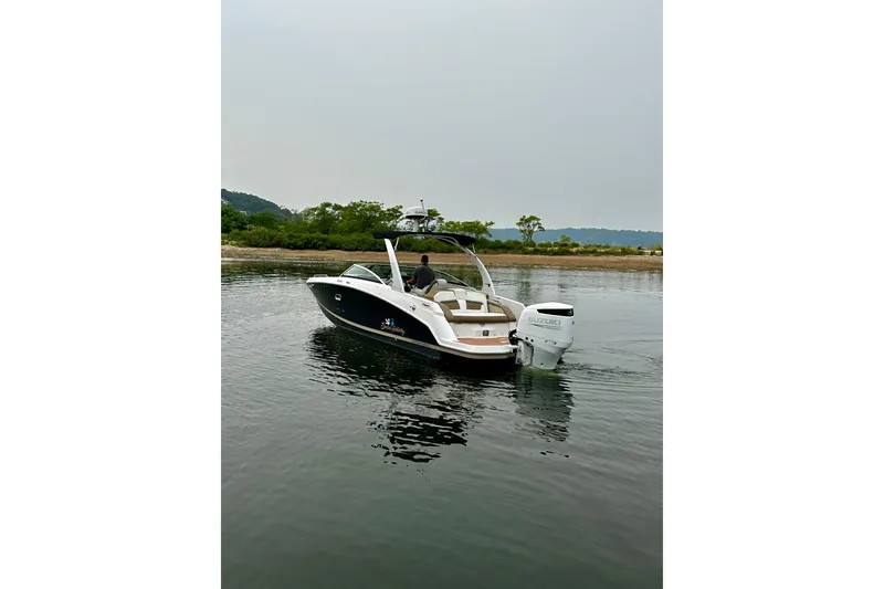 Slide: The Image of 2016 Four Winns Ho270 boat on calm water near a scenic shoreline. - 35