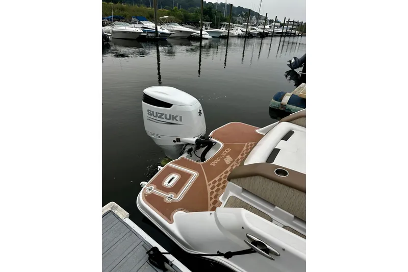 Slide: The Image of 2016 Four Winns Ho270 boat with Suzuki outboard motor docked at marina. - 47