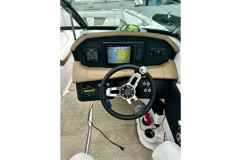 Slide: The Image of 2016 Four Winns Ho270 boat dashboard with steering wheel and navigation display. - 51
