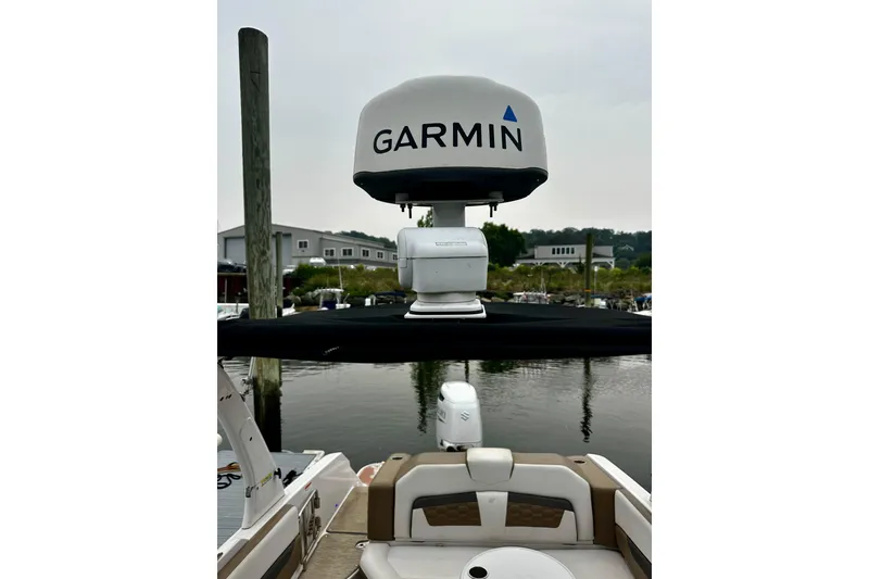 Slide: The Image of 2016 Four Winns Ho270 boat with Garmin radar, docked at marina. - 55