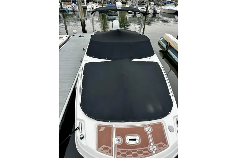 Slide: The Image of 2016 Four Winns Ho270 boat with black covers docked at marina. - 64