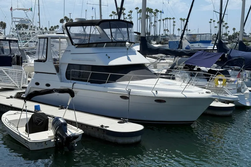 Slide: The Image of 2000 Carver 356 Aft Cabin Motor Yacht docked at marina, surrounded by other boats. - 0