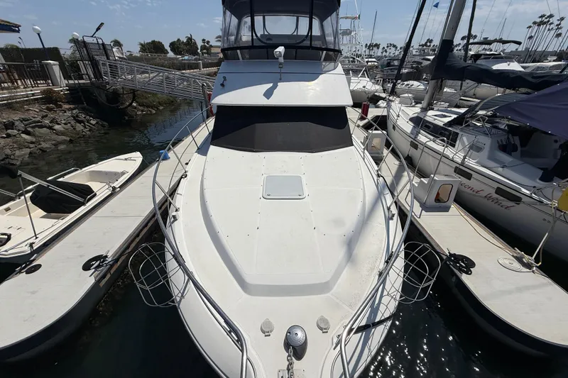 Slide: The Image of 2000 Carver 356 Aft Cabin Motor Yacht docked at marina, surrounded by other boats. - 1