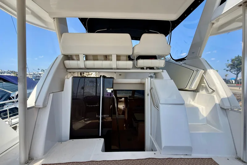 Slide: The Image of 2000 Carver 356 Aft Cabin Motor Yacht interior with seating and cabin entrance. - 13