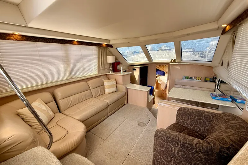Slide: The Image of Luxurious interior of 2000 Carver 356 Aft Cabin Motor Yacht with plush seating and dining area. - 15