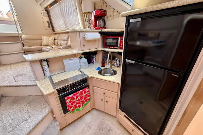 Slide: The Image of 2000 Carver 356 Aft Cabin Motor Yacht interior with kitchen and seating area. - 19