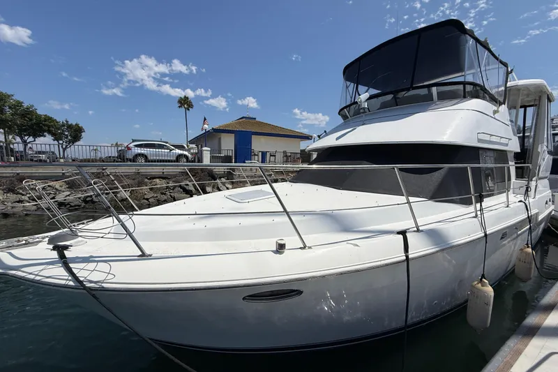 Slide: The Image of 2000 Carver 356 Aft Cabin Motor Yacht docked at marina under clear sky. - 2