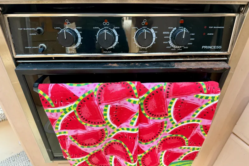 Slide: The Image of Oven controls on a 2000 Carver 356 Aft Cabin Motor Yacht with watermelon-patterned towel. - 21