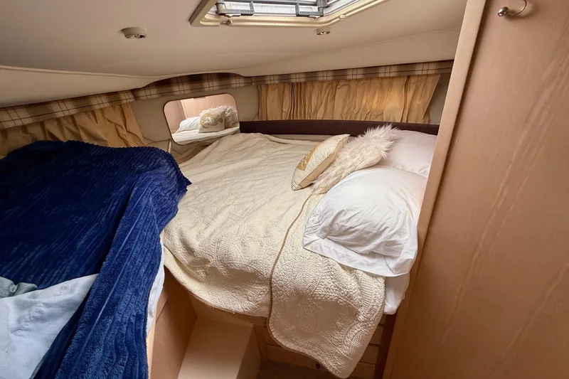 Slide: The Image of Cozy bedroom in 2000 Carver 356 Aft Cabin Motor Yacht with plush bedding. - 22