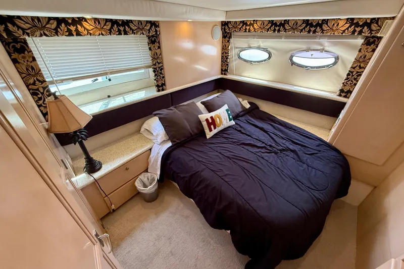Slide: The Image of Luxurious bedroom in 2000 Carver 356 Aft Cabin Motor Yacht with elegant decor. - 26