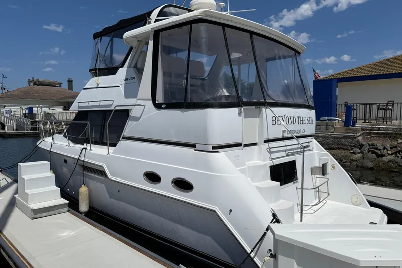 Slide: The Image of 2000 Carver 356 Aft Cabin Motor Yacht docked at marina under clear sky. - 3
