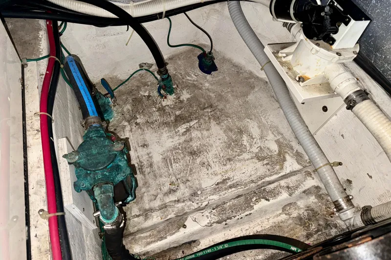 Slide: The Image of Bilge area of 2000 Carver 356 Aft Cabin Motor Yacht with visible plumbing components. - 30