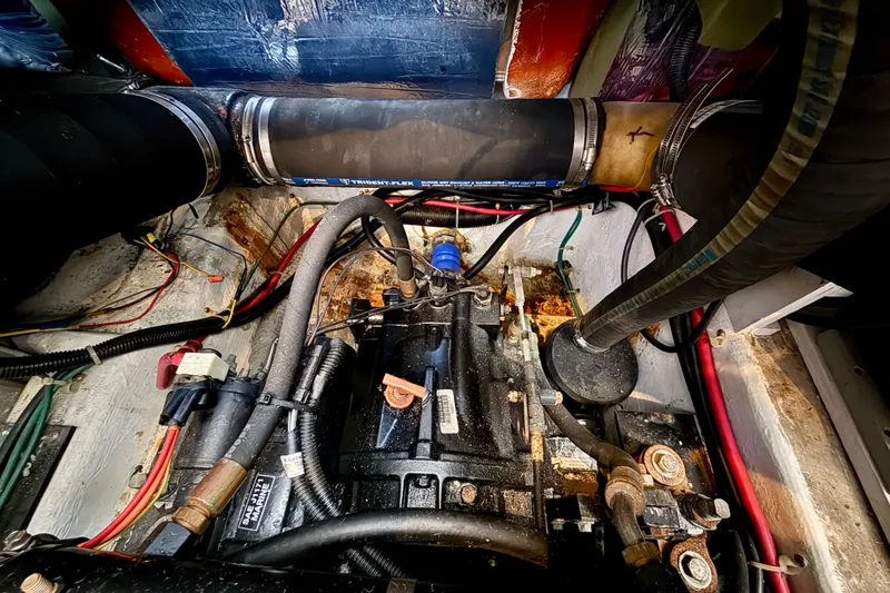 Slide: The Image of Engine compartment of 2000 Carver 356 Aft Cabin Motor Yacht with visible hoses and wiring. - 33