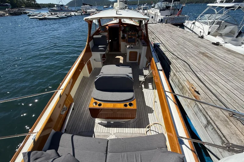 Slide: The Image of 2001 Hinckley Classic Picnic Boat docked, featuring spacious deck and comfortable seating. - 15