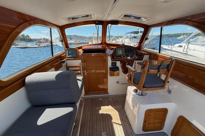 Slide: The Image of Interior of a 2001 Hinckley Classic Picnic Boat with wooden accents and nautical views. - 27