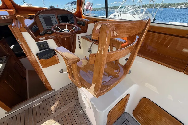 Slide: The Image of 2001 Hinckley Classic Picnic Boat helm with polished wood and modern navigation equipment. - 44