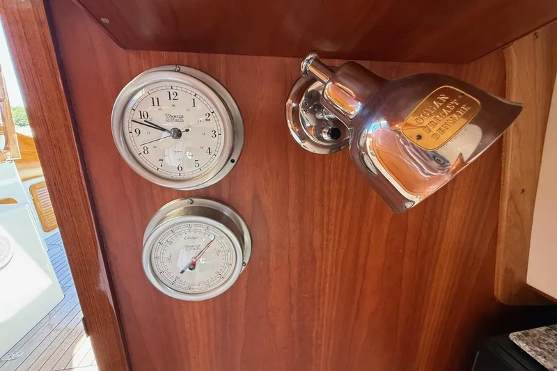 Slide: The Image of Hinckley Classic Picnic Boat 2001 interior with clock, barometer, and brass light fixture. - 64