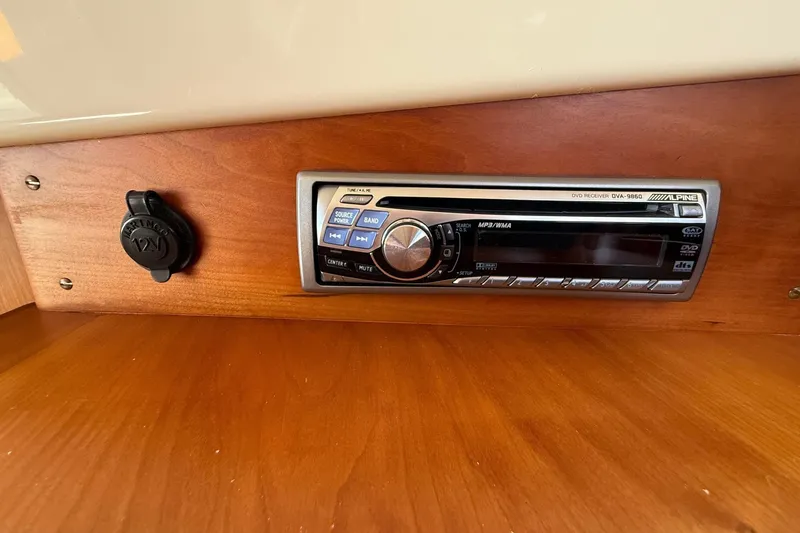Slide: The Image of 2001 Hinckley Classic Picnic Boat interior with Alpine stereo system and 12V outlet. - 67