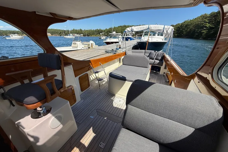 Slide: The Image of 2001 Hinckley Classic Picnic Boat interior with elegant seating and scenic waterfront view. - 17