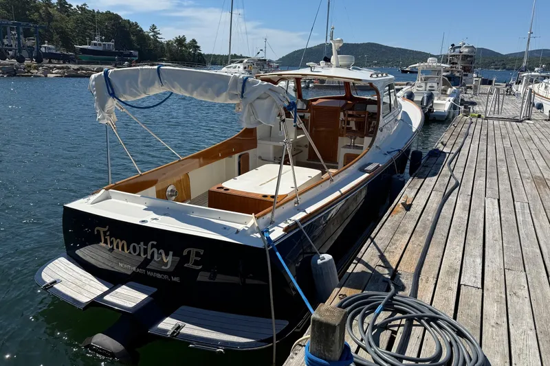 Slide: The Image of 2001 Hinckley Classic Picnic Boat docked at a scenic harbor. - 2