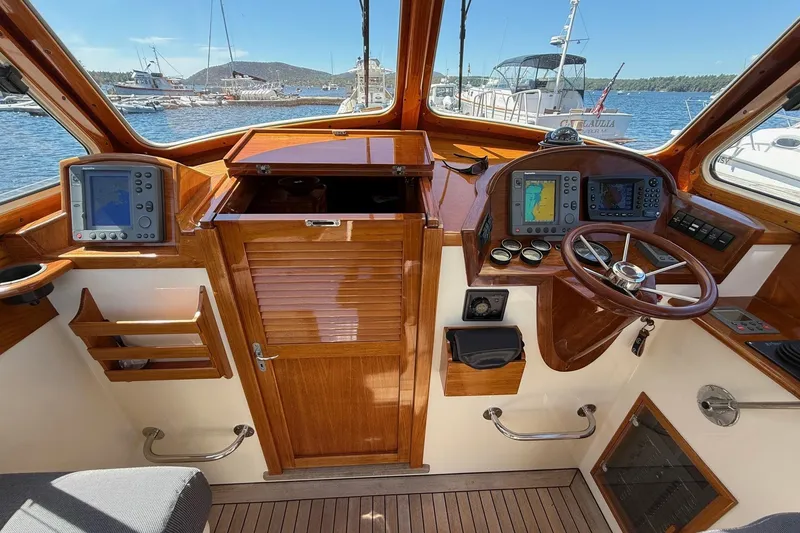 Slide: The Image of 2001 Hinckley Classic Picnic Boat cockpit with wooden dashboard and navigation equipment. - 29