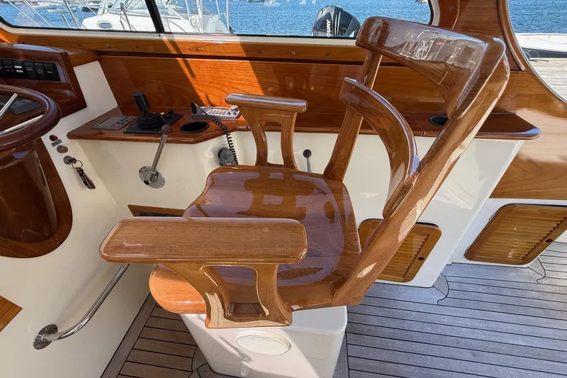 Slide: The Image of Wooden helm chair on 2001 Hinckley Classic Picnic Boat, showcasing elegant craftsmanship. - 46