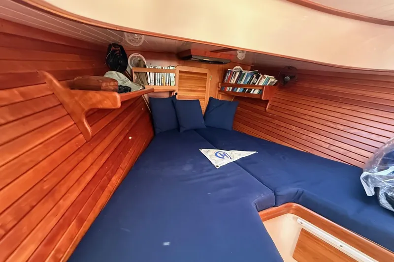Slide: The Image of Cozy cabin interior of 2001 Hinckley Classic Picnic Boat with wooden paneling and blue cushions. - 53