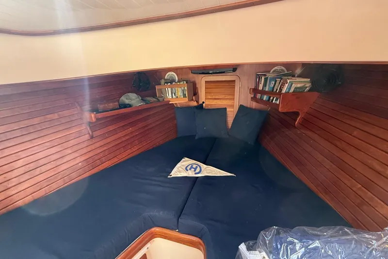Slide: The Image of 2001 Hinckley Classic Picnic Boat interior with cozy wooden cabin and blue cushions. - 54
