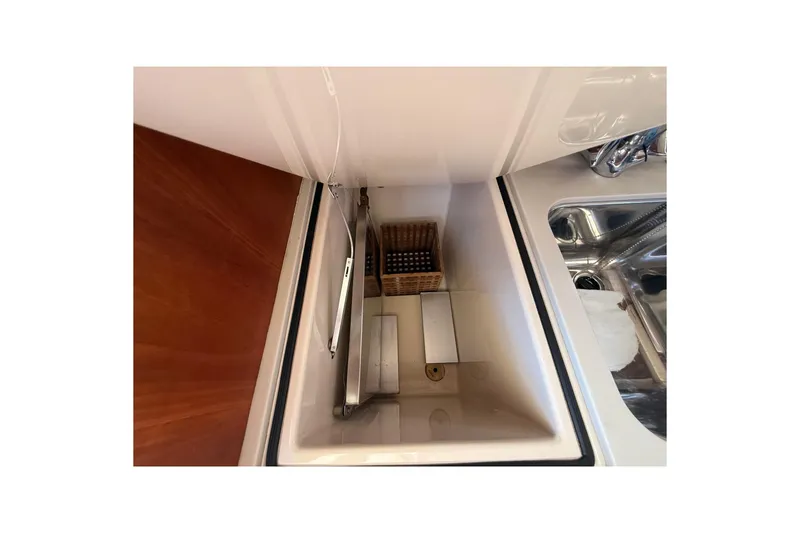 Slide: The Image of Interior view of 2001 Hinckley Classic Picnic Boat's storage compartment and sink area. - 66