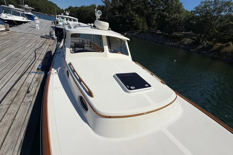 Slide: The Image of 2001 Hinckley Classic Picnic Boat docked by a wooden pier on a sunny day. - 8