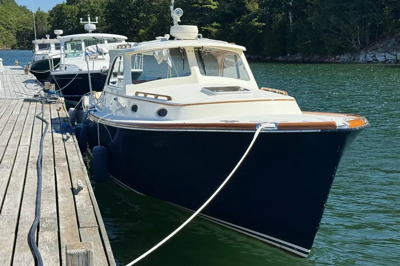 The Image of 2001 Hinckley Classic Picnic Boat docked on a serene lake. - 0