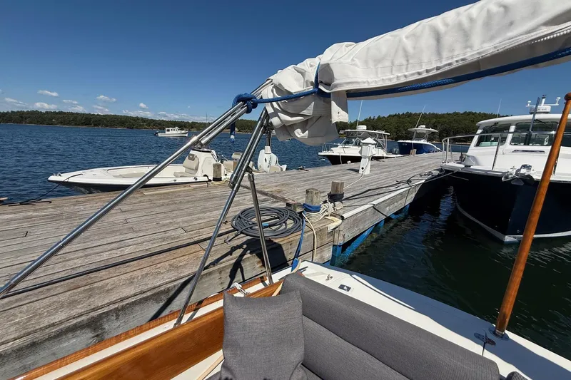 Slide: The Image of Hinckley Classic Picnic Boat 2001 docked at a scenic marina with clear blue skies. - 25