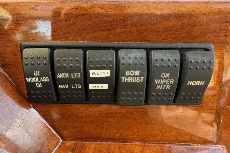 Slide: The Image of Control panel switches on a 2001 Hinckley Classic Picnic Boat dashboard. - 40