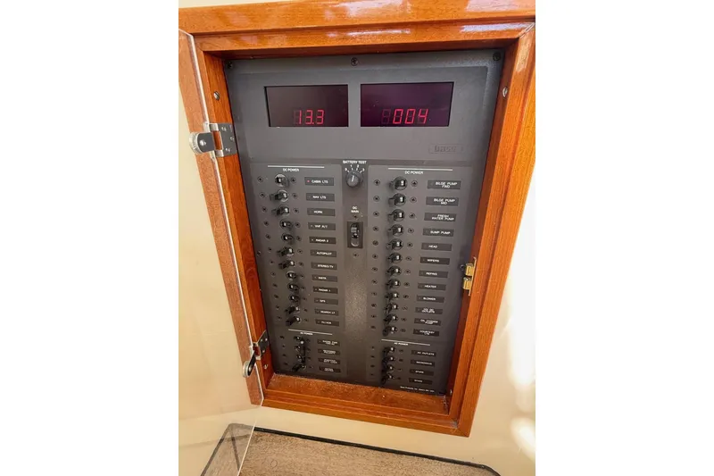 Slide: The Image of Electrical panel of a 2001 Hinckley Classic Picnic Boat with digital displays and switches. - 42