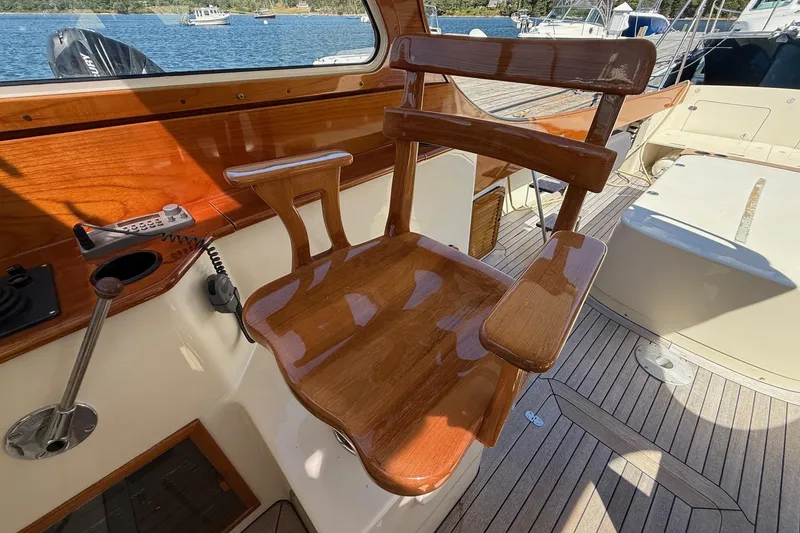Slide: The Image of 2001 Hinckley Classic Picnic Boat with polished wooden helm seat and deck view. - 45