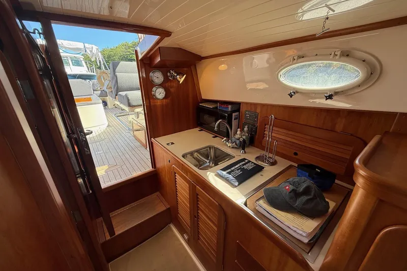 Slide: The Image of Interior of 2001 Hinckley Classic Picnic Boat with kitchenette and seating area. - 49