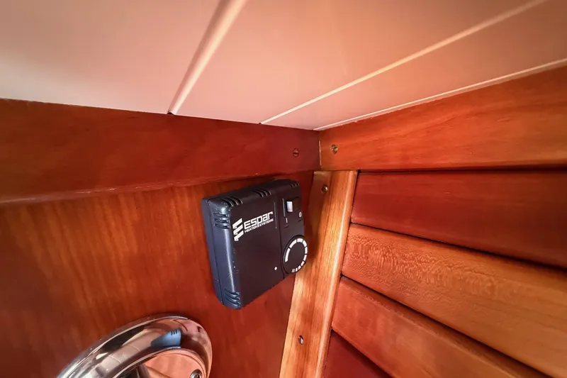 Slide: The Image of Interior of 2001 Hinckley Classic Picnic Boat with Espar heating control on wooden panel. - 63