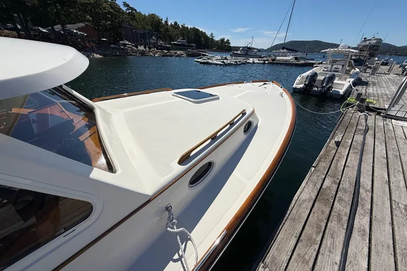 Slide: The Image of 2001 Hinckley Classic Picnic Boat docked at a scenic marina. - 7