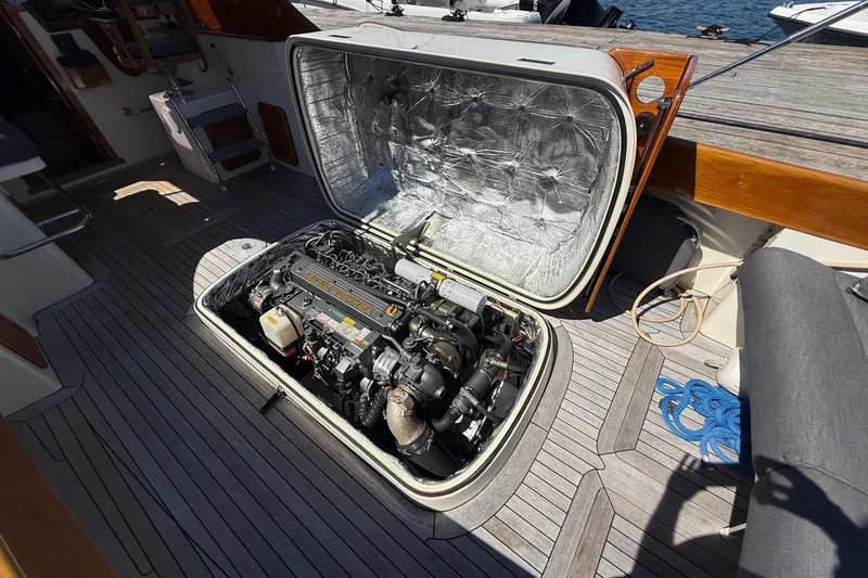 Slide: The Image of Open engine compartment of a 2001 Hinckley Classic Picnic Boat on a wooden deck. - 70
