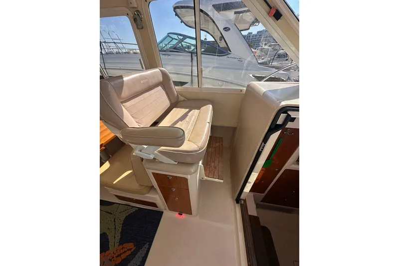 Slide: The Image of Interior of 2002 True North 38 Heritage boat with beige seating and wooden accents. - 17