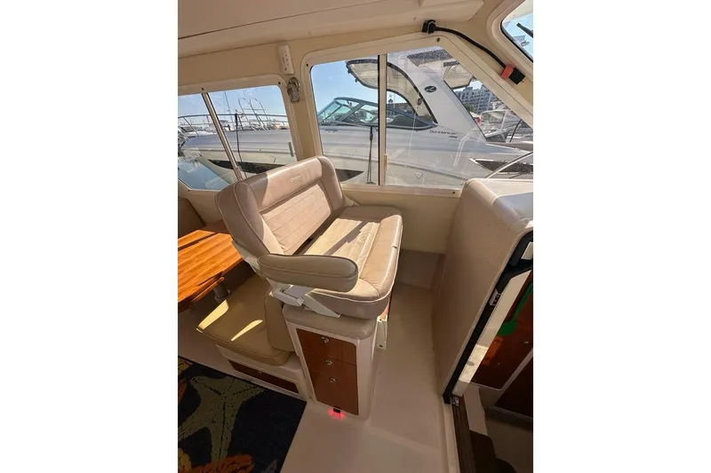 Slide: The Image of Interior of 2002 True North 38 Heritage boat with beige seating and wooden accents. - 18