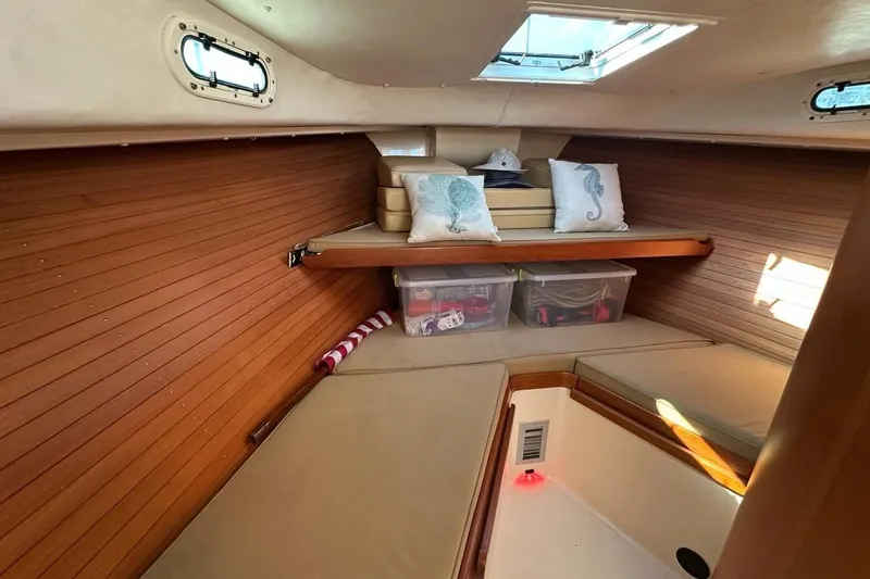 Slide: The Image of Cozy cabin interior of 2002 True North 38 Heritage boat with cushions and storage. - 19