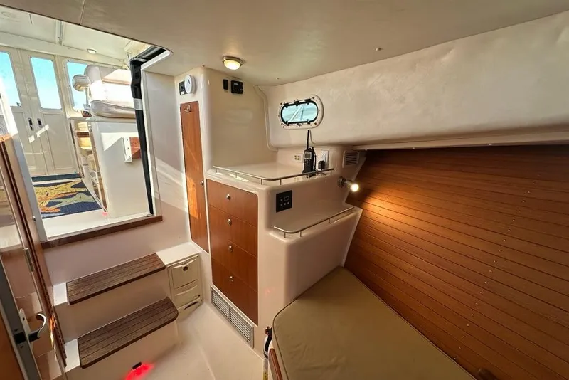 Slide: The Image of Interior of 2002 True North 38 Heritage boat with wooden accents and cozy seating. - 20