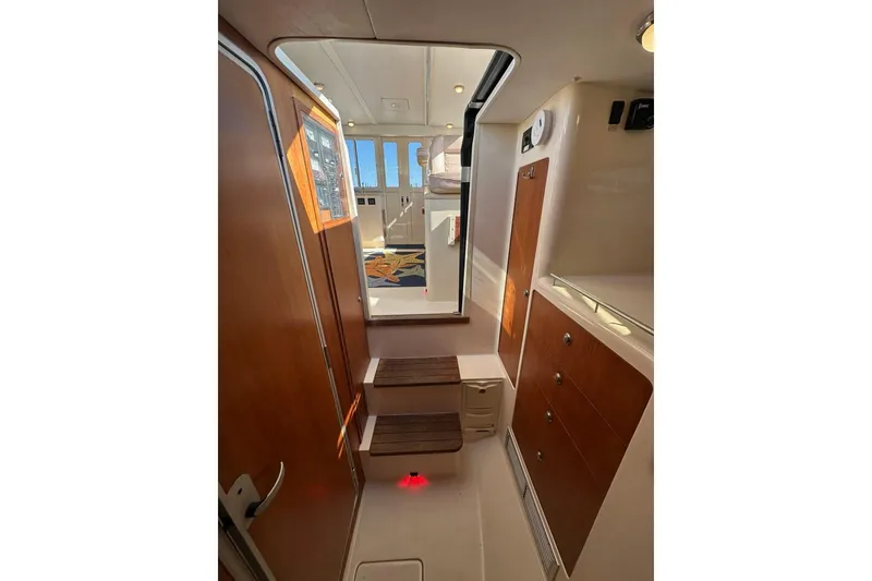 Slide: The Image of Interior of 2002 True North 38 Heritage boat with wooden cabinetry and steps. - 21