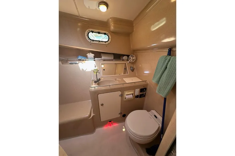 Slide: The Image of Compact bathroom in 2002 True North 38 Heritage boat with toilet, sink, and towel. - 22