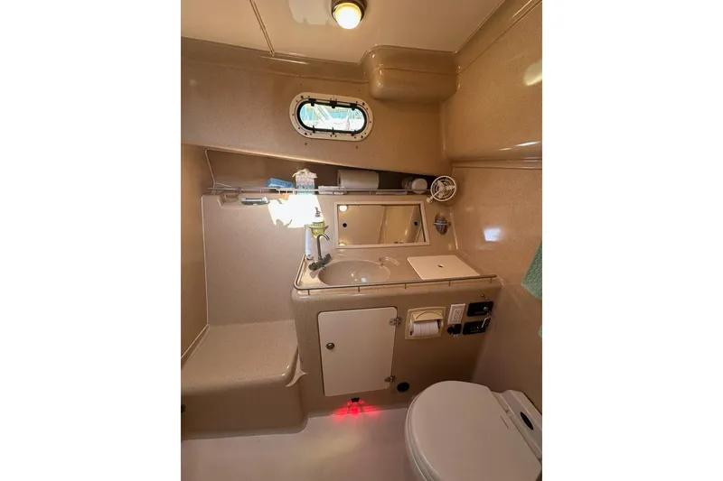 Slide: The Image of 2002 True North 38 Heritage yacht bathroom with sink, mirror, and porthole window. - 24