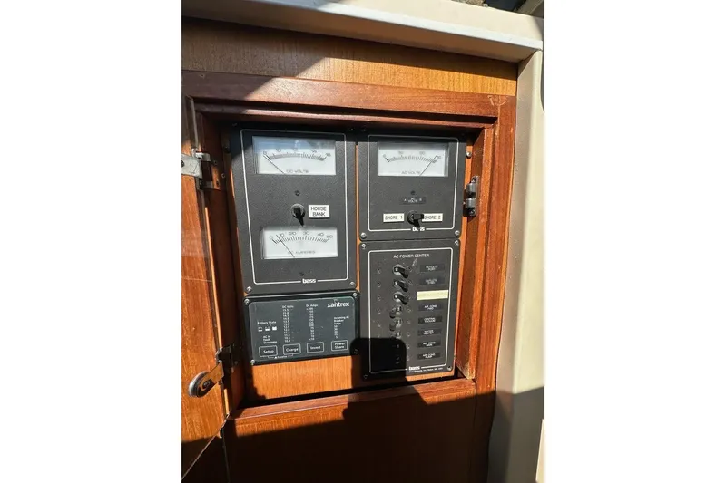 Slide: The Image of Electrical panel on a 2002 True North 38 Heritage boat, featuring gauges and switches. - 26