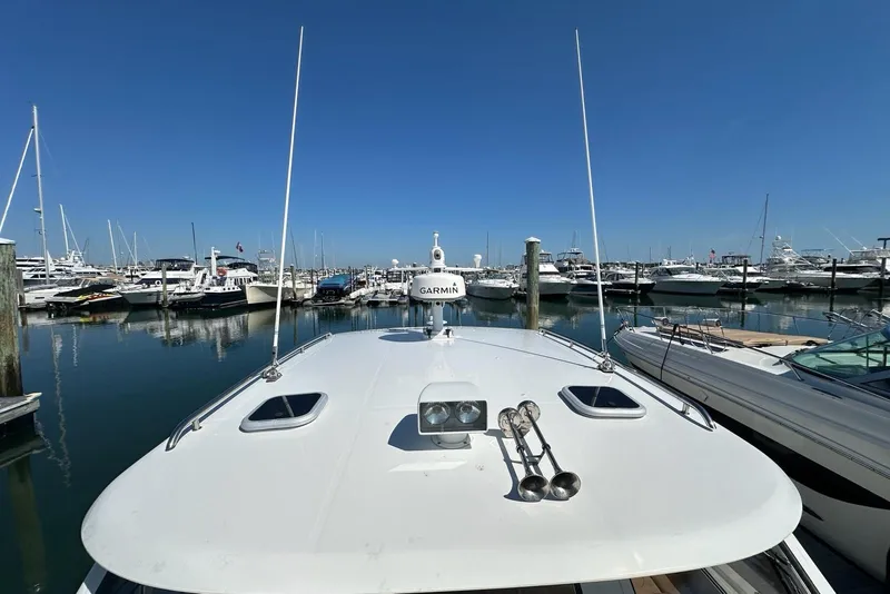 Slide: The Image of 2002 True North 38 Heritage boat docked in a marina under clear blue skies. - 36