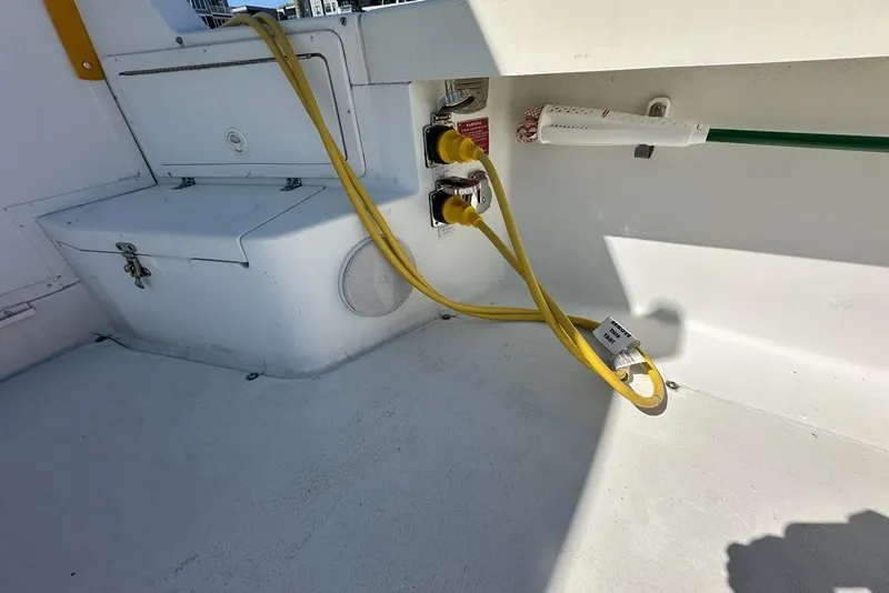 Slide: The Image of 2002 True North 38 Heritage boat deck with yellow power cables and storage compartment. - 39