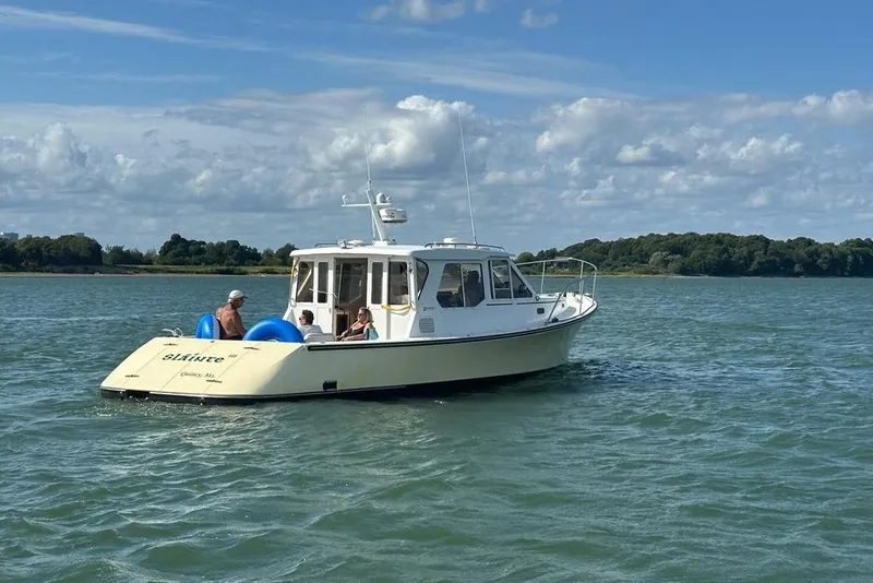 Slide: The Image of 2002 True North 38 Heritage boat cruising on a sunny day with passengers onboard. - 4